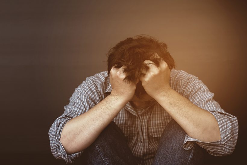 Person som tar CBD mot ångest Sad man holding head with hand